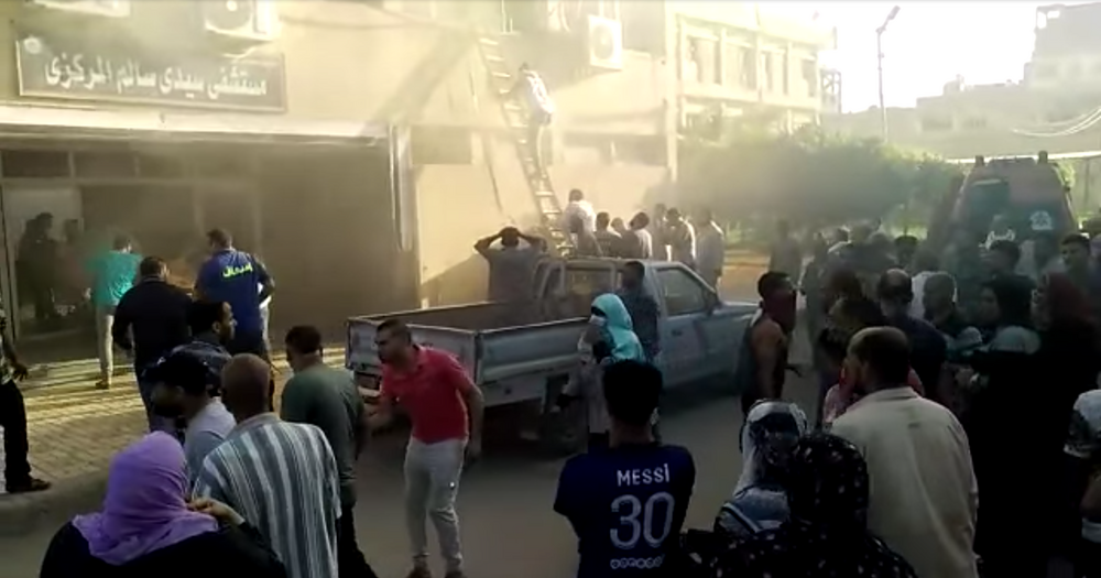 People try to rescue patients at the fire-hit hospital on Tuesday. (Videograb)