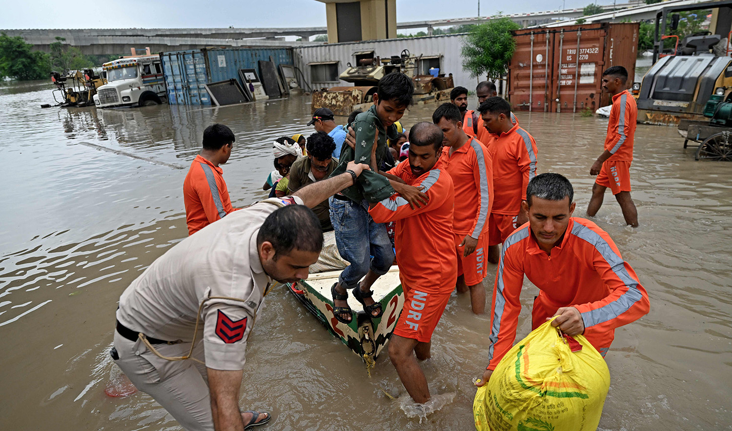 National Disaster Response Force (NDRF) personnel rescue people from the flooded waters of Yamuna River after heavy monsoon rains in New Delhi, India, on July 12, 2023. (AFP)