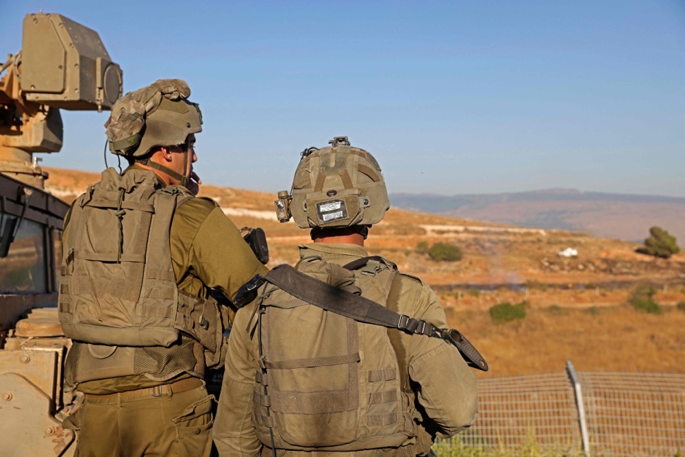 Israeli soldiers take position near the Lebanon border, in the town of Metulla in northern Israel on July 12, 2023. (AFP)