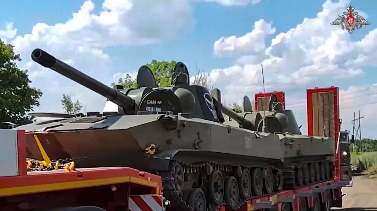 Artillery systems belonging to Russia's Wagner military contractor are parked at an undisclosed location ahead of their handover to the Russian military. (Russian Defense Ministry Press Service via AP)