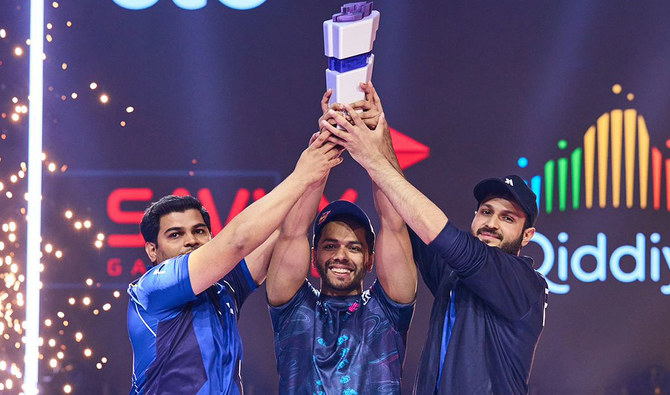 From left: Pakistani gamers Atif Butt, Arslan Ash and Imran Khan lift the Tekken 7 Nations Cup trophy at the Boulevard Riyadh City in Riyadh on July 9, 2023. (Courtesy Gamers 8)