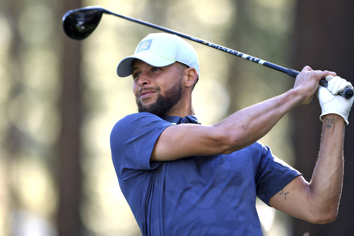 Stephen Curry watches a tee shot on the 16th hole during a practice round at American Century Championship golf tournament Wednesday. On Saturday Curry shot his second career hole-in-one at Edgewood Tahoe. (San Francisco Chronicle via AP)