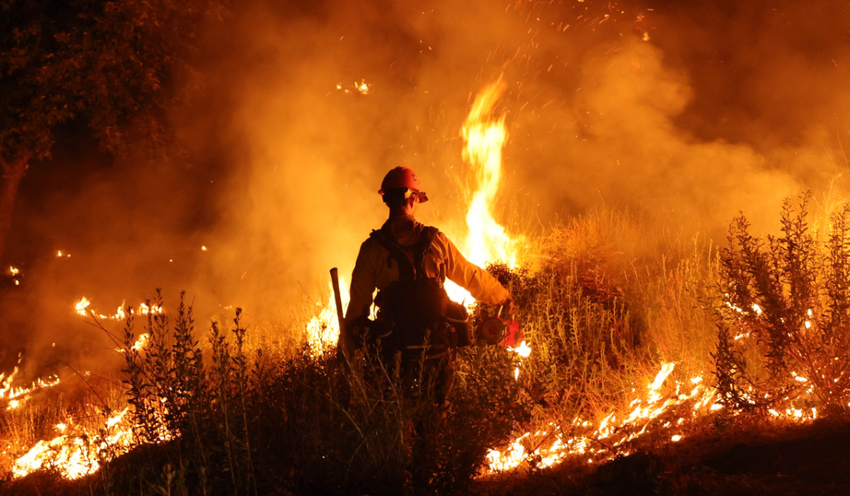A firefighter monitors and sets a controlled burn as the Rabbit Fire scorched over 7,500 acres in Moreno Valley, Riverside County, California on July 15, 2023. (AFP)