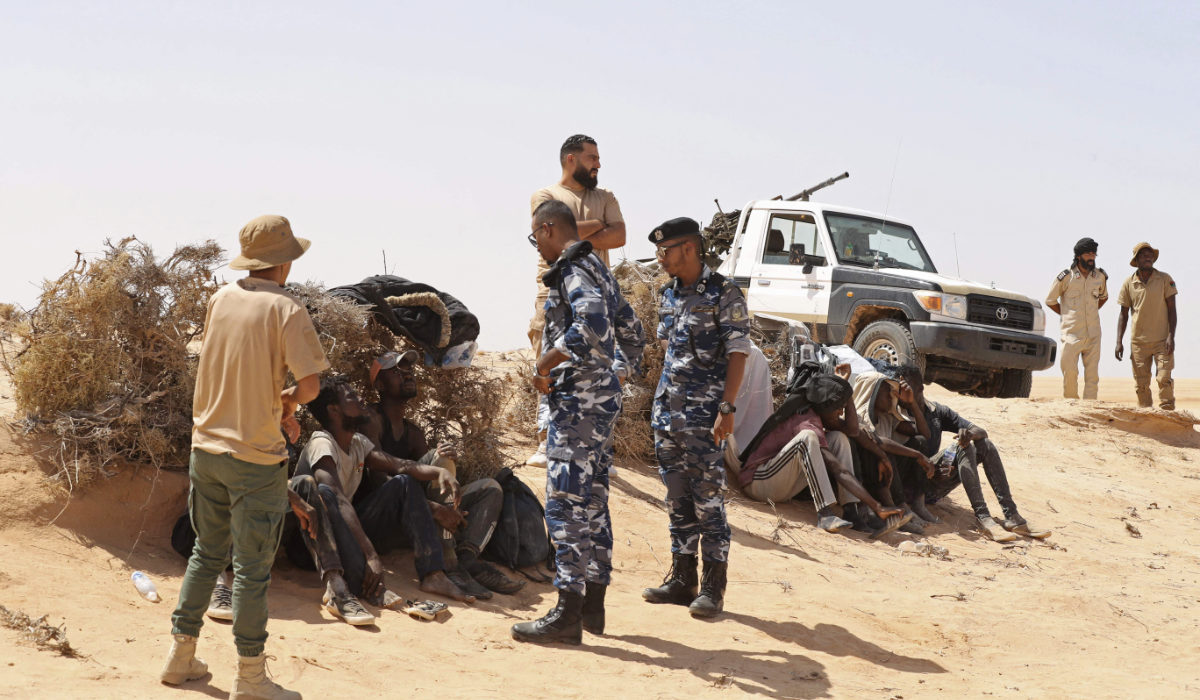 Libyan border guards rescue migrants from sub-Saharan African countries who claim to have been abandoned in the desert by Tunisian authorities without water or shelter, in an uninhabited area near the border town of Al-Assah on July 16, 2023. (AFP)