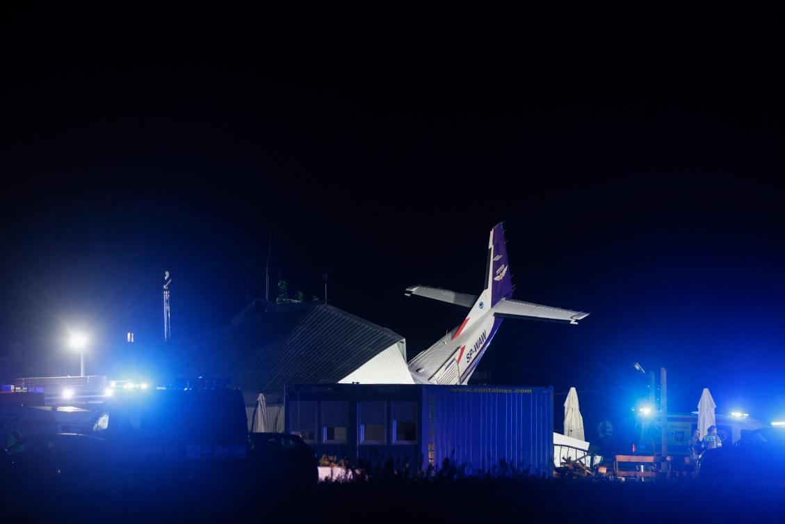 A Cessna 208 small plane is seen into an hangar after a crash in an airfield in the village of Chrcynno, near Warsaw, on July 17, 2023. "We have at least seven injured and five dead," Health Minister Adam Niedzielski wrote on Twitter, on July 17, 2023. (AFP)