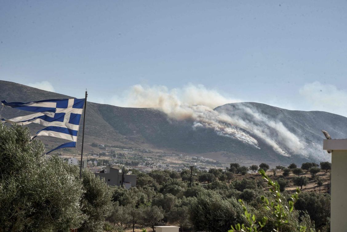 A blaze raged uncontrolled and burned forest in the area of Dervenochoria about 30 km north of Athens, a fire service official said on Tuesday. (AFP)