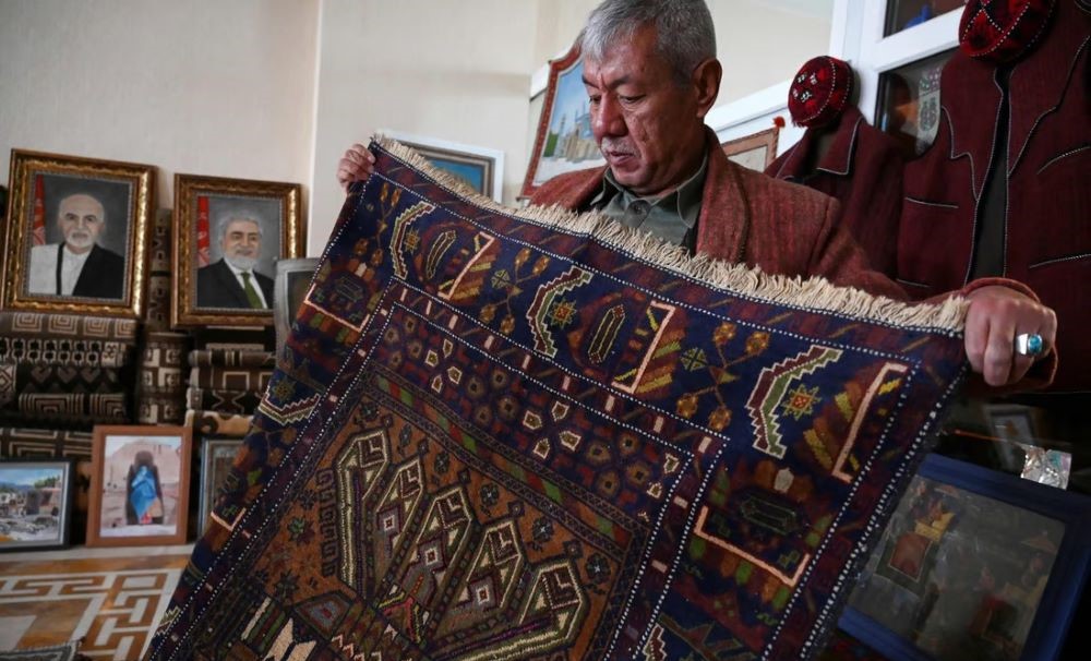 A vendor displays a rug at his shop in Bamiyan, Afghanistan. (AFP)