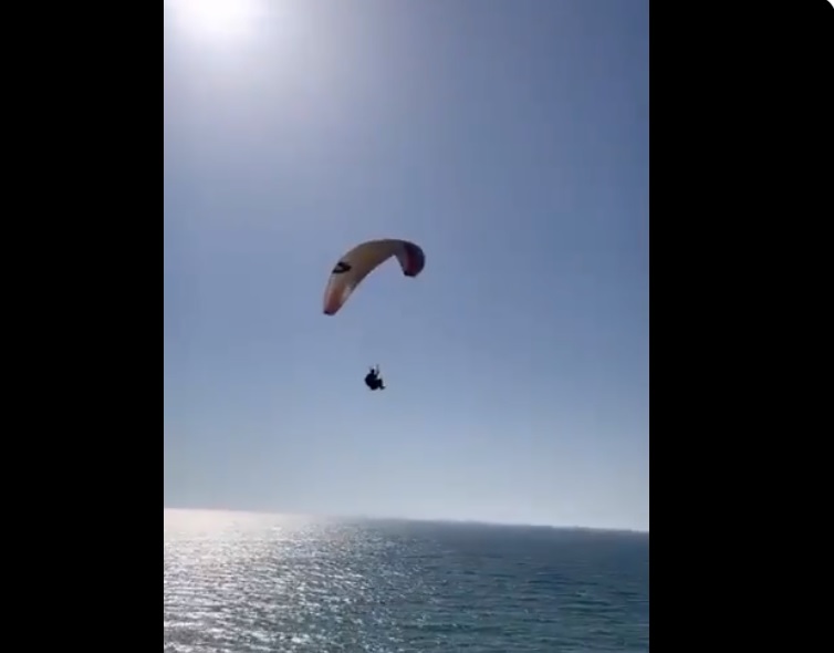 Screengrabs taken from a video posted by the European Union Delegation to the Palestinians shows EU envoy Sven Kühn von Burgsdorff during and after paragliding in a rare flight designed to draw attention to the blockaded Palestinian enclave.. (Twitter/@WAFANewsEnglish)