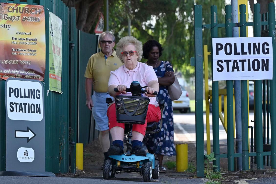 Voters leave a polling station in the northwest London constituency of Uxbridge and South Ruislip on July 20, 2023. In a surprise result, the Conservatives retained the Uxbridge and South Ruislip seat after Boris Johnson’s shock decision to quit parliament last month. (AFP)