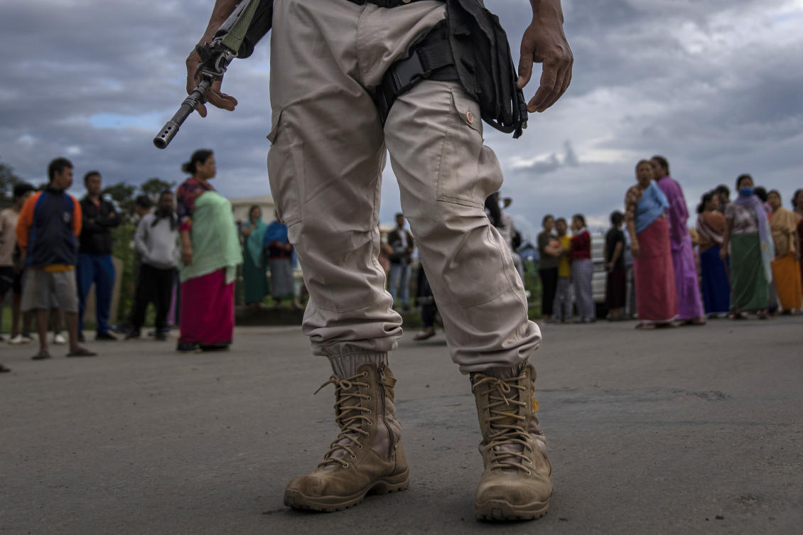 Clashes between vigilante gangs from rival communities in Manipur have continued intermittently, pitting the majority Meitei, who are mostly Hindus, against the mainly Christian Kuki. Above, a policeman stands guard as members of Meira Paibis block traffic to check vehicles for members from rival tribal Kuki community. (AP)