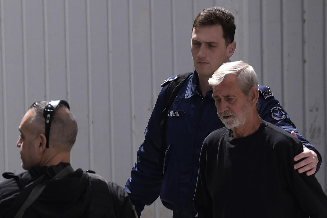 Police officers escort Briton David Hunter as he leaves the grounds of the courthouse complex after a trial on a premeditated murder charge in the death of his ill wife, in Cyprus on Mar. 21, 2023. (AP/File)