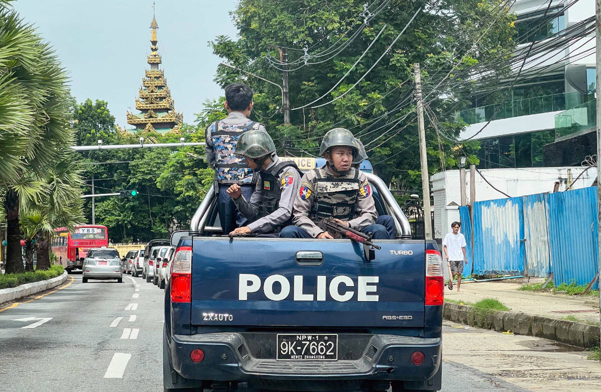 Police patrol on a street in Yangon on July 19, 2023, on the 76th Martyrs' Day, which marks the anniversary of the assassination of independence leaders including general Aung San, father of the currently deposed and imprisoned leader Aung San Suu Kyi. (AFP)