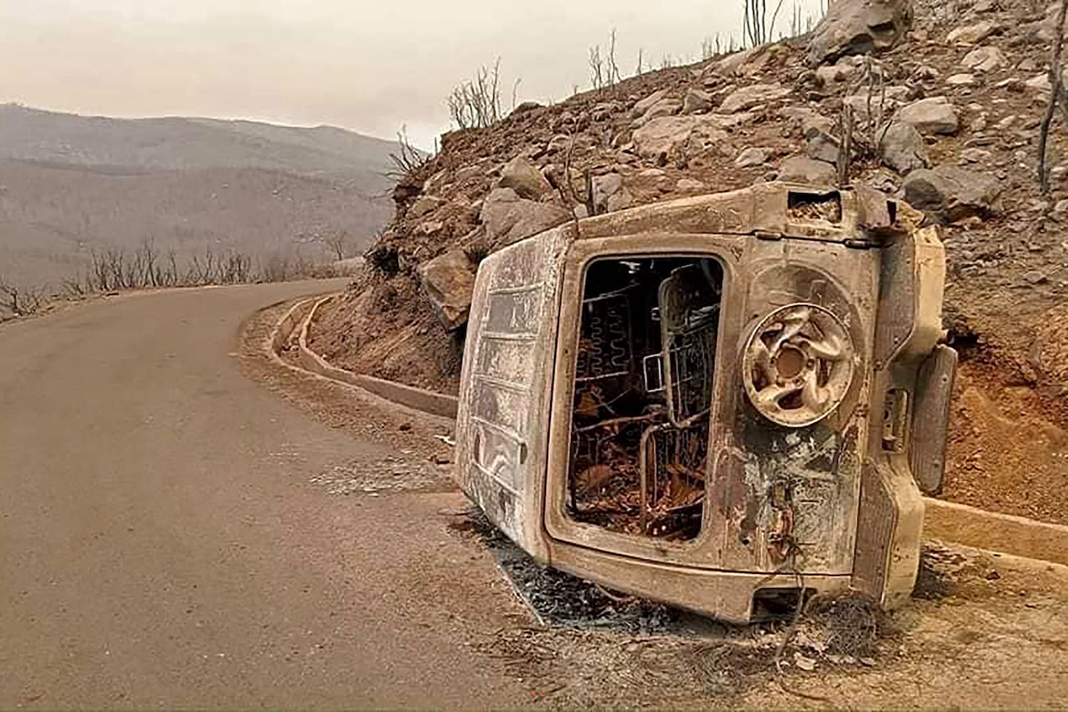 The aftermath of Algeria's wildfires in Toudja town can be seen as temperatures hit 48 degrees Celsius. (AFP)