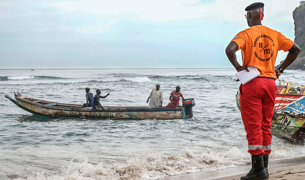 Senegalese rescue personnel and local fishermen prepare a pirogue on Monday for a rescue operation after a boat capsized off the coast of Dakar. (AFP)