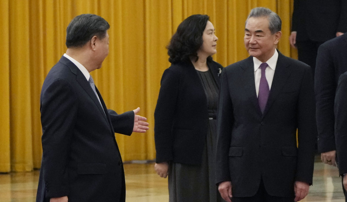 Chinese President Xi Jinping at left walks near State Councillor Wang Yi at right during a welcome ceremony for the Algerian President Abdelmadjid Tebboune, unseen, held at the Great Hall of the People in Beijing, Tuesday, July 18, 2023. (AP)