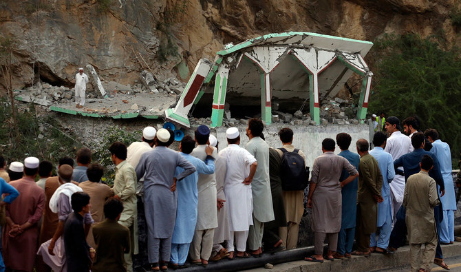 People Stand and watch the damaged mosque after a suicide bomber attack inside a roadside mosque in the Khyber district in Khyber Pakhtunkhwa province, of Pakistan, on July 25, 2023. (AP)