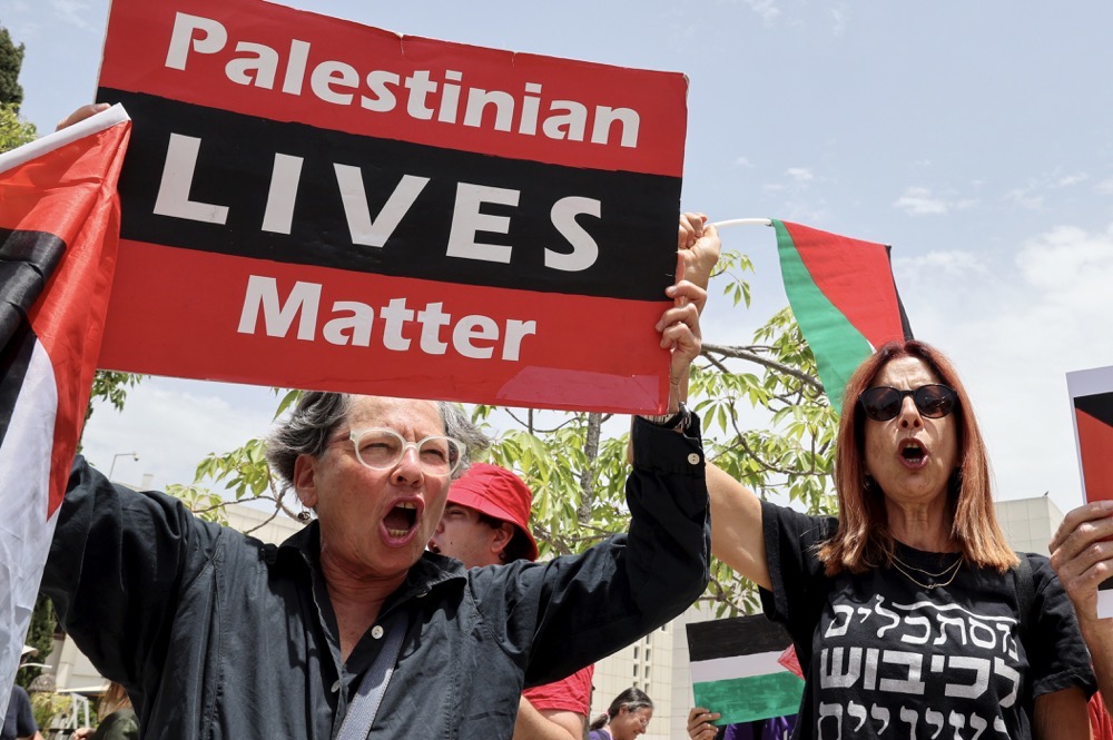 Protests against proposed legislation banning the Palestinian flag. (AFP)