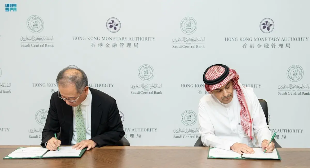 Saudi Central Bank governor Ayman Al-Sayari, right, with Hong Kong Monetary Authority’s CEO Eddie Yue sign an agreement on developing bilateral ties. (SPA)