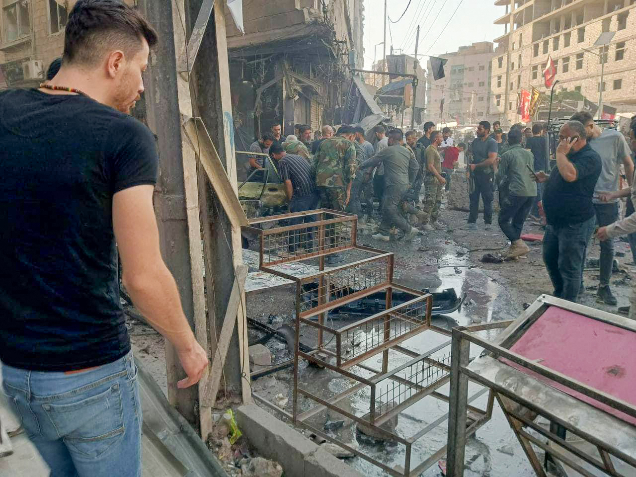 People gather at the site of an explosion in the town of Sayyida Zeinab on the outskirts of Damascus on July 27, 2023. (AFP)