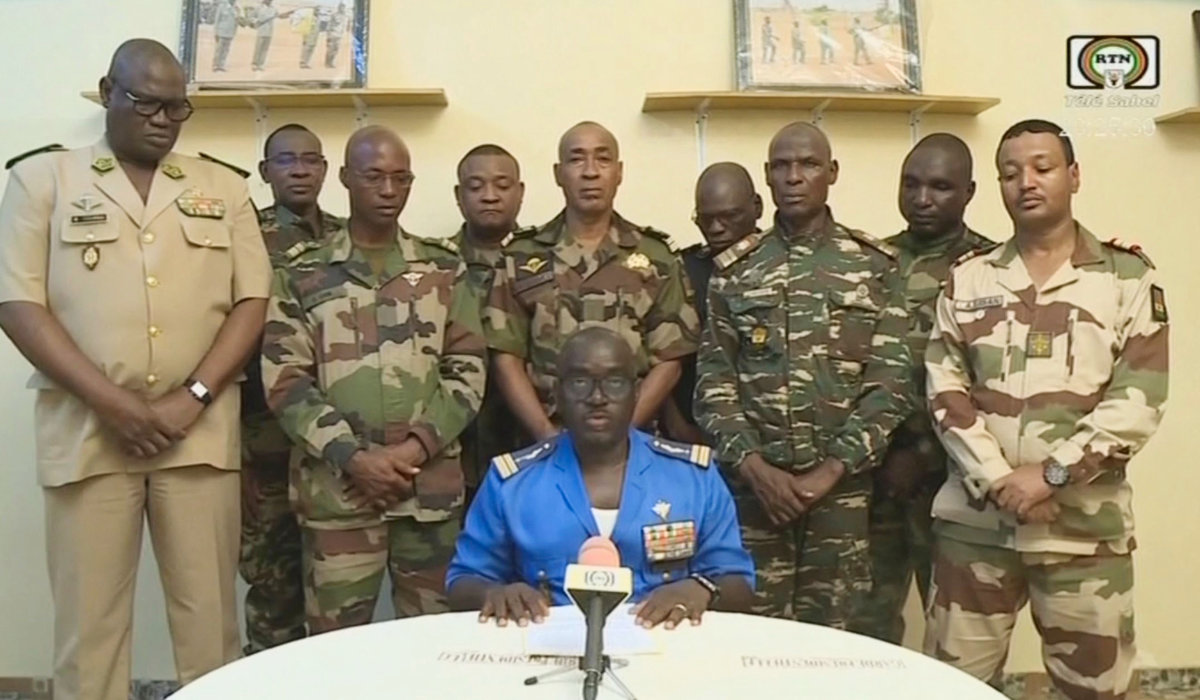 This video frame grab image obtained by AFP from ORTN - Télé Sahel on July 26, 2023 shows Colonel Major Amadou Abdramane (C), spokesperson for the National Committee for the Salvation of the People (CNSP) speaking during a televised statement. (AFP)