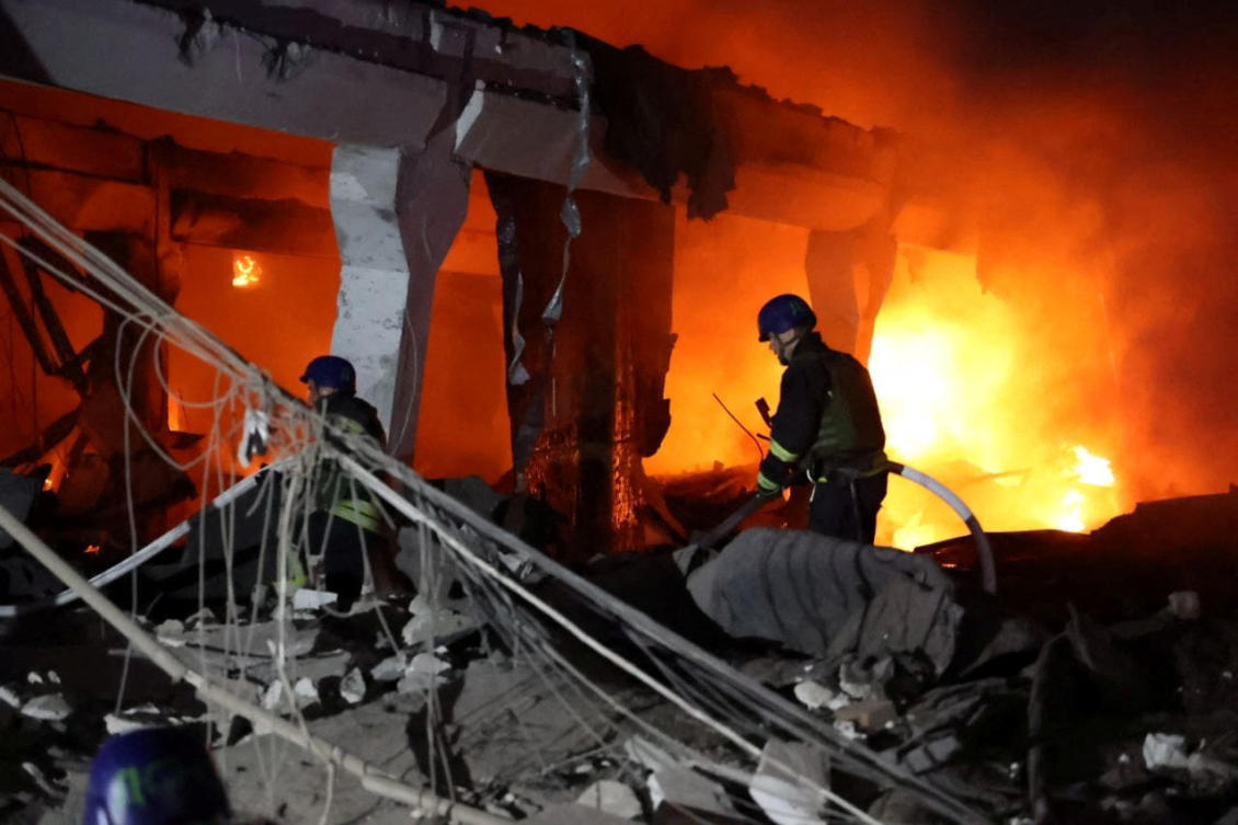 Firefighters work at a site of an apartment building damaged by a Russian missile strike in Dnipro on July 28, 2023. (Reuters)