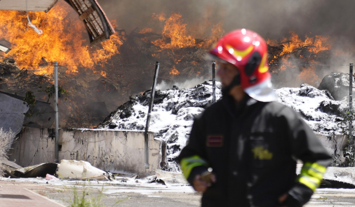 Italian Firefighters work to extinguish a fire which broke out in a garbage dump near Ciampino Airport in Rome, Saturday, July 29, 2023. (AP)