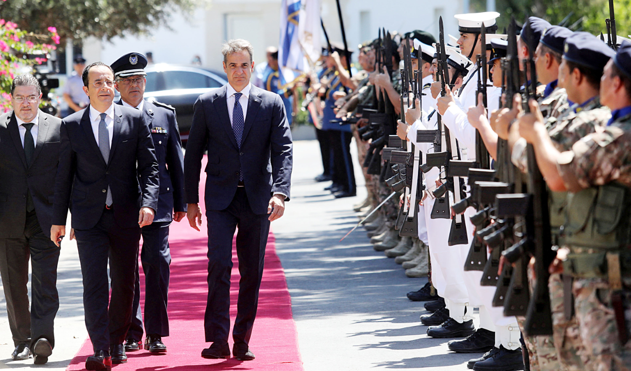 Cyprus President Nikos Christodoulides with Greek Prime Minister Kyriakos Mitsotakis during Monday’s welcome ceremony at the Presidential Palace in Nicosia. (Reuters)
