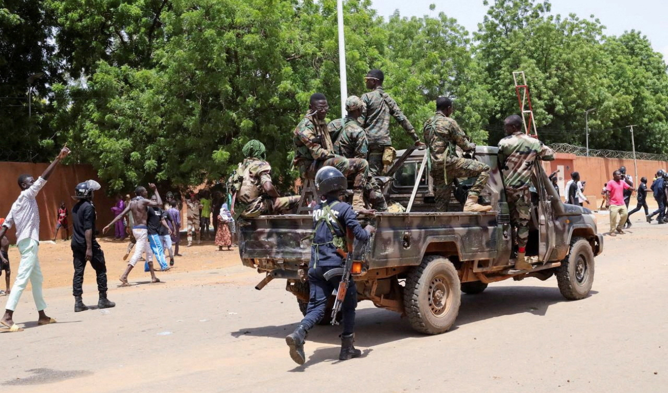 Niger’s security forces prepare to disperse pro-junta demonstrators in Niamey. The West African regional bloc has warned of possible military intervention. (Reuters)