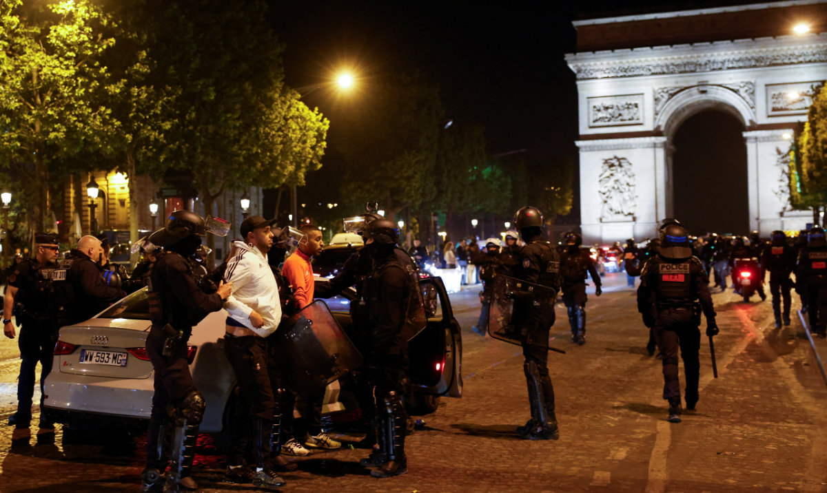 Police detain young people during the fifth night of protests in the Champs Elysees area, in Paris, July 2, 2023. (Reuters)