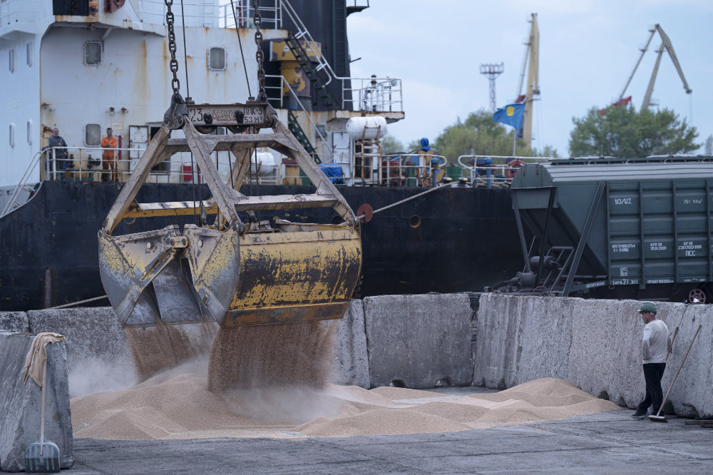 Workers load grain at a grain port in Izmail, Ukraine, on April 26, 2023. (AP)