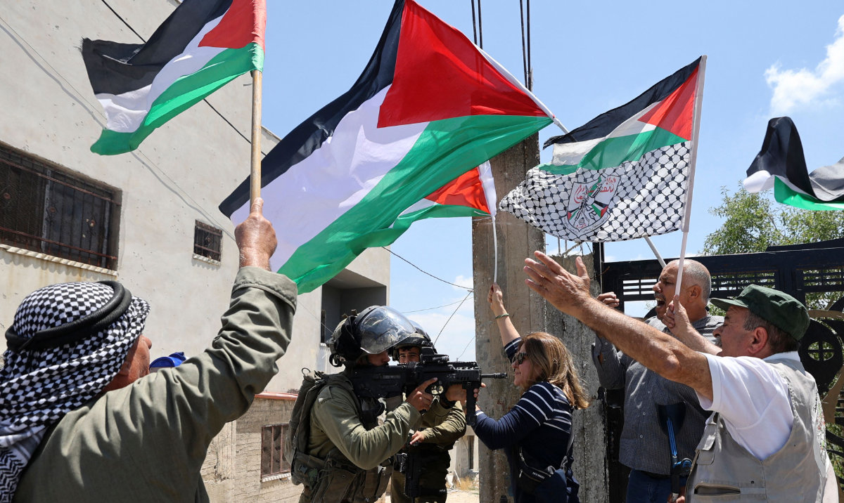 Demonstrators confront Israeli soldiers following a protest in the occupied West Bank. (AFP)