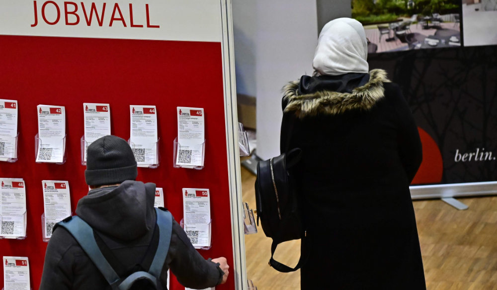 A visitor looks for a job offer on a job fair for migrants launched by the German job center in Berlin. (AFP file photo)