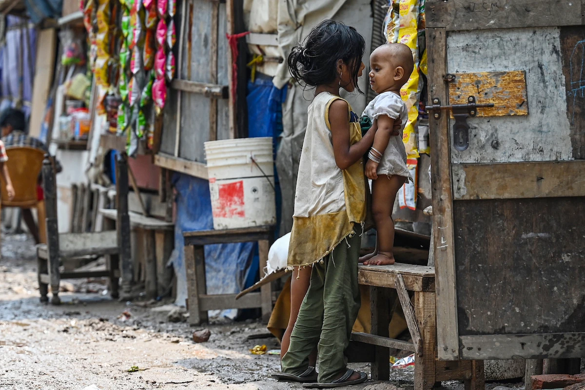 Rohingya refugee children stand along a street at a refugee camp in New Delhi. (File/AFP)