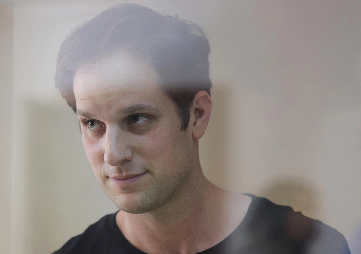 Wall Street Journal reporter Evan Gershkovich, who was arrested in March while on a reporting trip and accused of espionage, stands behind a glass wall of an enclosure for defendants before a court hearing to consider an appeal against his detention, in Moscow, Russia June 22, 2023. (REUTERS)