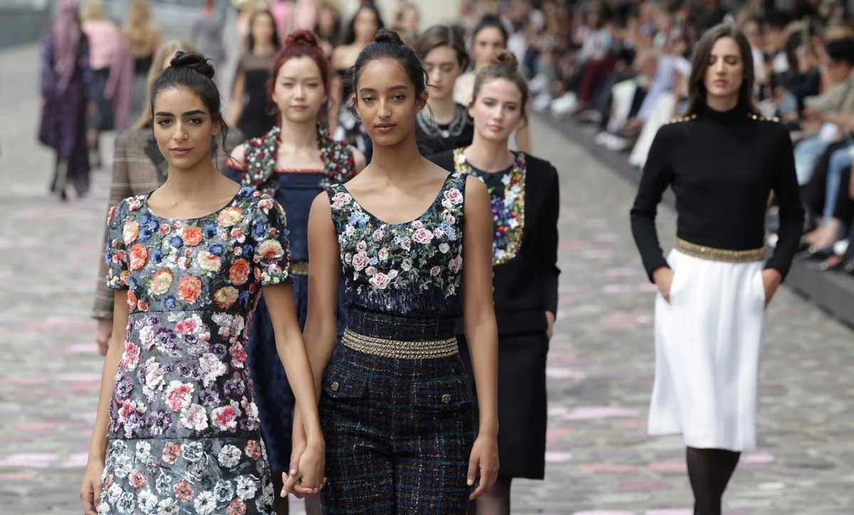 British-Moroccan model Nora Attal and Somali-Danish model Mona Tougaard walked the cobblestoned banks of the Seine River on Tuesday for Chanel’s latest haute couture collection at Paris Fashion Week. (Getty Images)