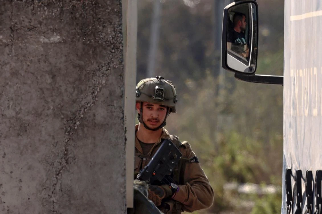 An Israeli soldier mans a checkpoint near the settlement of Kadumim in the West Bank, following an attack claimed by the armed wing of Hamas, July 6, 2023. (AFP)