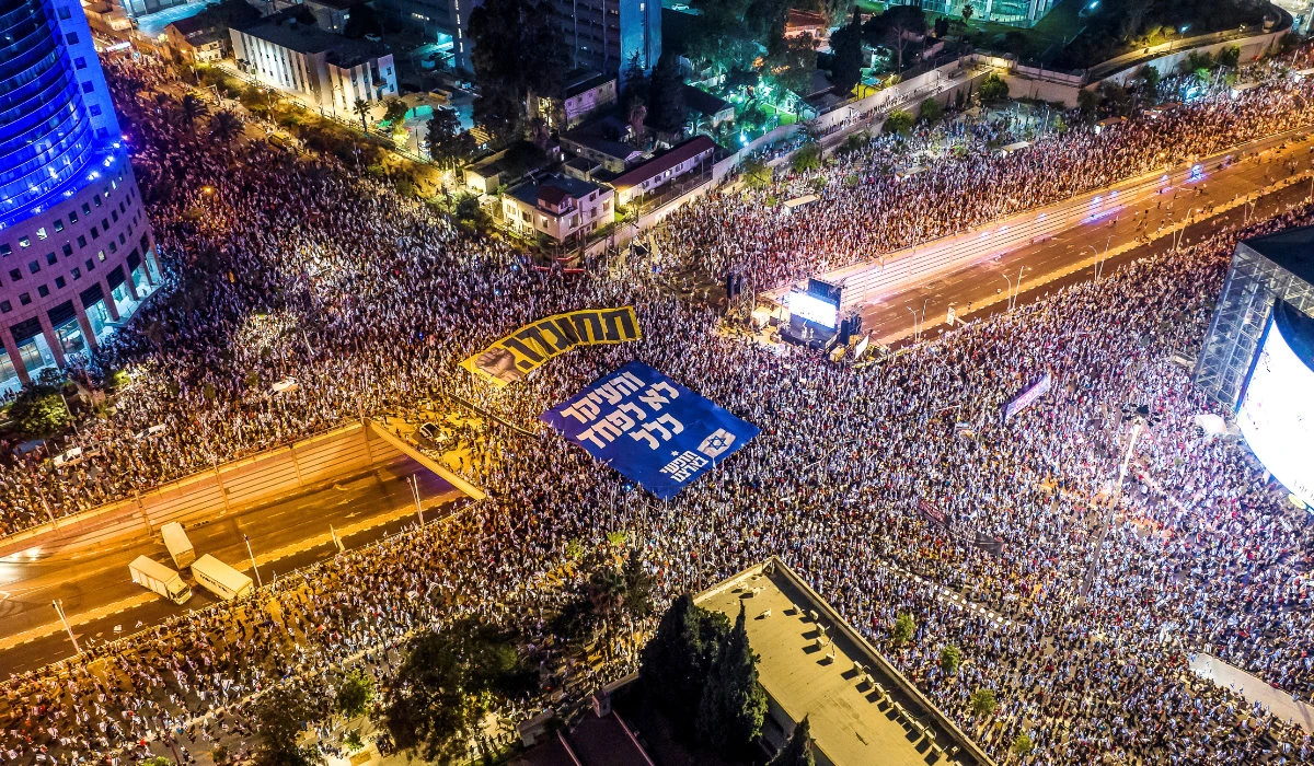 An aerial view shows protesters holding banners with the words in Hebrew "resist" and "The main thing is not to be afraid at all" as they take part in a demonstration against Israeli Prime Minister Benjamin Netanyahu and his nationalist coalition government's judicial overhaul, in Tel Aviv, Israel July 8, 2023. (REUTERS)