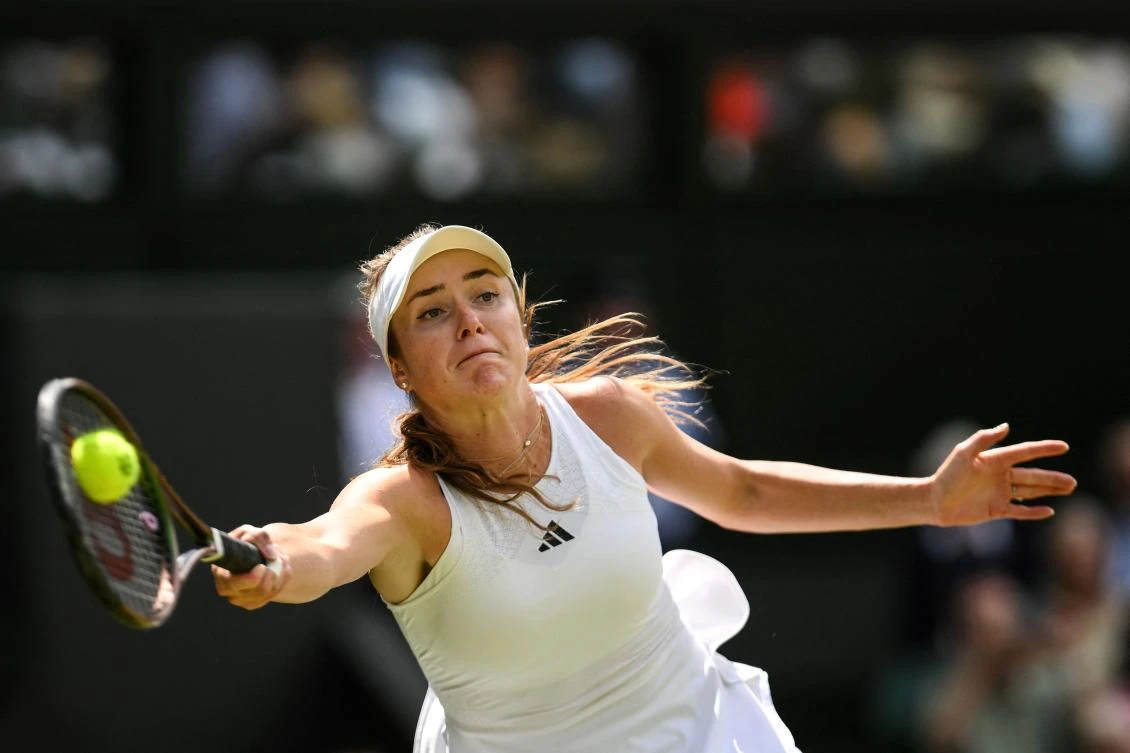 Ukraine’s Elina Svitolina returns the ball to Poland’s Iga Swiatek during their women’s singles quarter-finals tennis match on the ninth day of the 2023 Wimbledon Championships at The All England Tennis Club in Wimbledon, on July 11, 2023. (AFP)