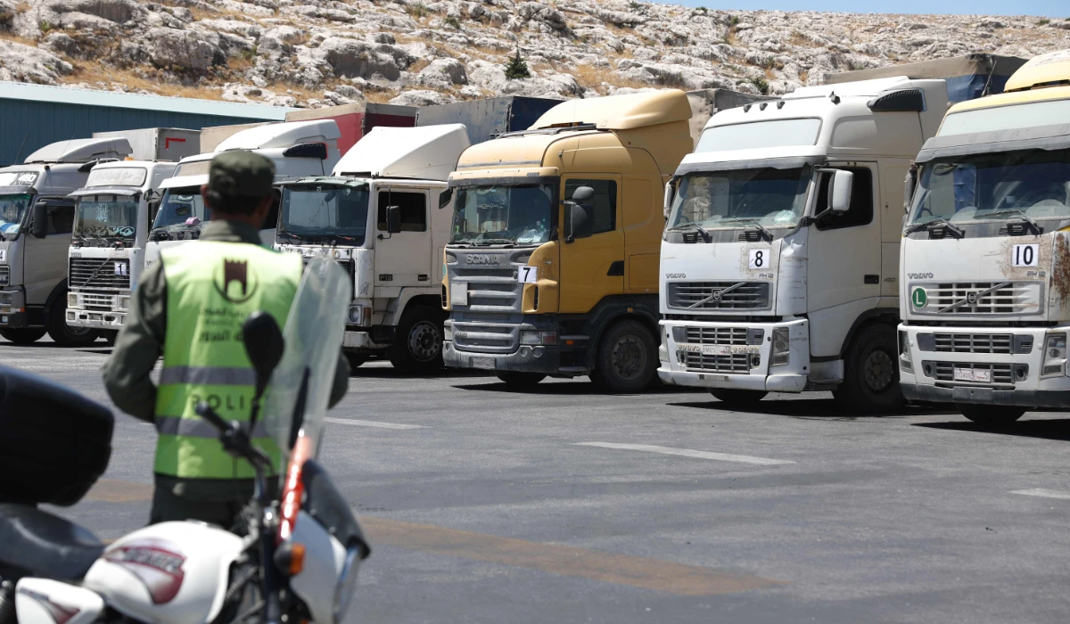 A convoy of trucks carrying humanitarian aid is seen parked after crossing the Syrian Bab al-Hawa border crossing with Turkey, on July 10, 2023. (AFP)