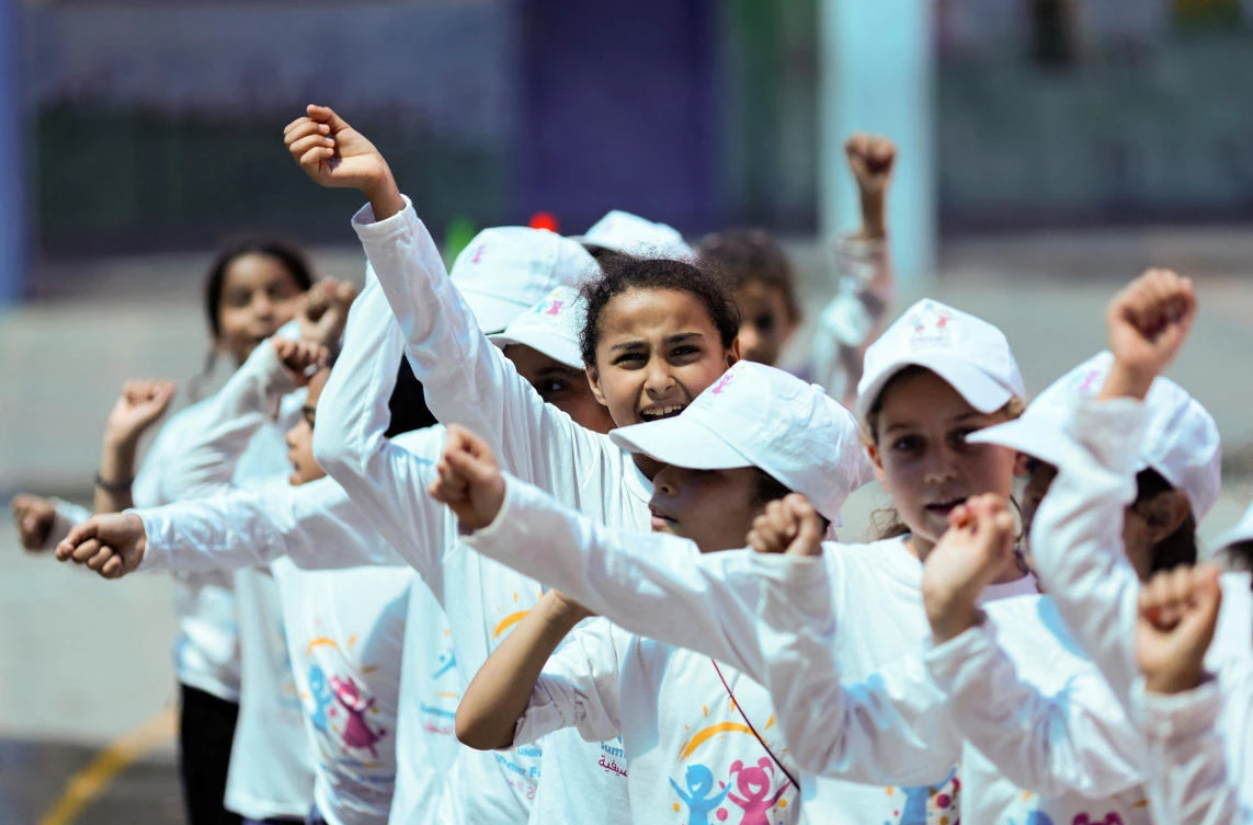 Palestinian refugee students attend an activity as part of “Fun Weeks” summer camps run by the United Nations Relief and Works Agency in a school in Beach refugee camp in Gaza on July 11, 2023. (Reuters)