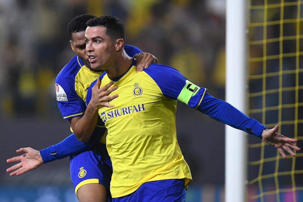 Nassr's Portuguese forward Cristiano Ronaldo (R) celebrates scoring his team's first goal during the Saudi Pro League football match between Al-Nassr and Al-Raed at the al-Awwal Park Stadium in the Saudi capital Riyadh on April 28, 2023. (File/AFP)