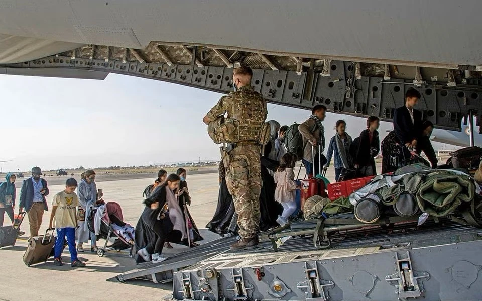 Afghans board a UK military aircraft at Kabul airport, Afghanistan, Aug. 16, 2021. (Reuters)