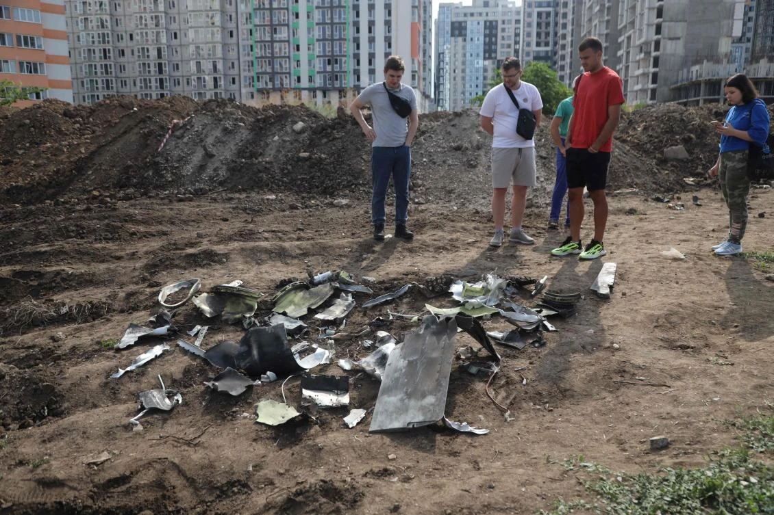 People look at fragments of a missile shot down during a night strike in Odesa on July 19, 2023. (AFP)