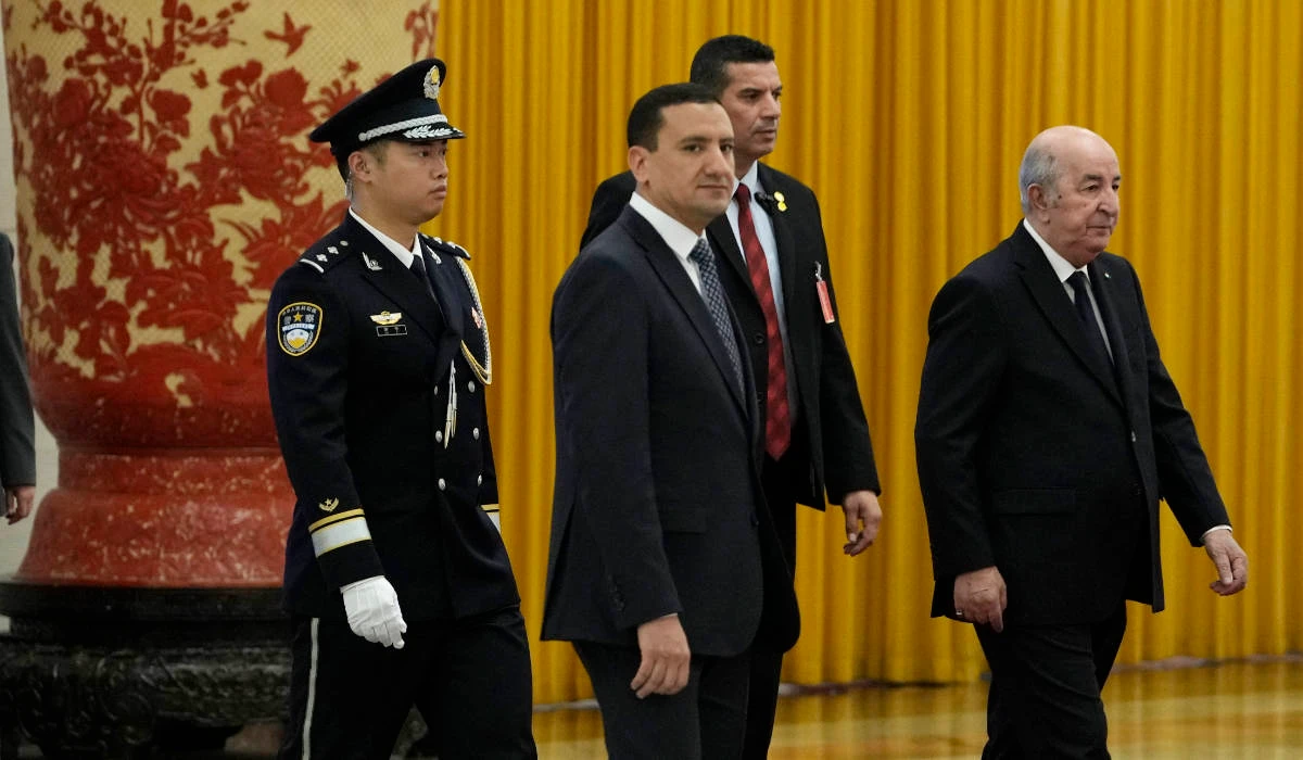 Algerian President Abdelmadjid Tebboune, right, arrives for talks with Chinese Premier Li Qiang, unseen, at the Great Hall of the People in Beijing, Wednesday, July 19, 2023. (AP)