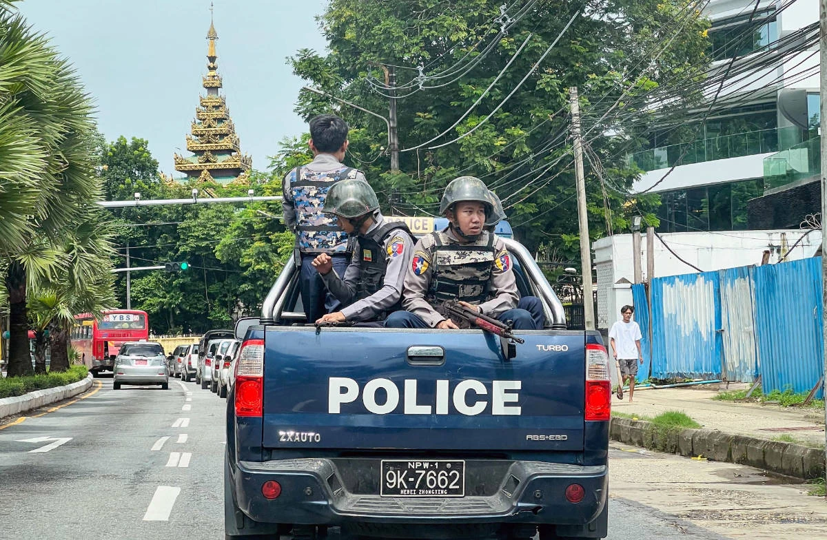 Police patrol on a street in Yangon on July 19, 2023, on the 76th Martyrs' Day, which marks the anniversary of the assassination of independence leaders including general Aung San, father of the currently deposed and imprisoned leader Aung San Suu Kyi. (AFP)