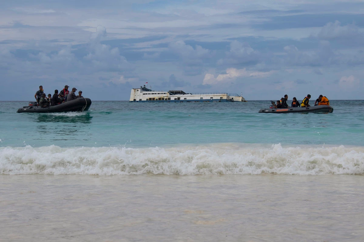 In this photo taken on July 5, 2018, rescuers search and examine a ferry which ran aground off the coast of Selayar island in South Sulawesi. An overcrowded ferry that sank off of Sulawesi Island early Monday left at least 15 people dead. (AFP file)