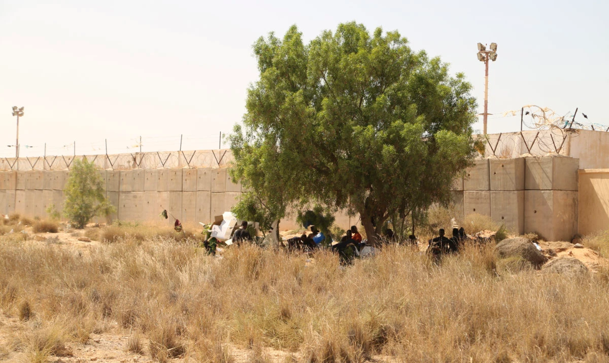 Migrants gather in a desert area on the Libyan side of the Tunisia-Libya border on Sunday July 23, 2023. (AP)