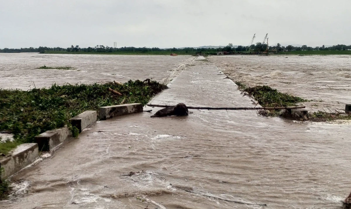 This handout photo taken on July 26, 2023 shows a flooded bridge in Tuao town, Cagayan province, after a river overflowed due to heavy rains brought about by Super Typhoon Doksuri. A super typhoon swept towards the northern Philippines, the country's weather agency said, triggering evacuation orders for coastal communities expected to bear the brunt of the powerful storm. (AFP)