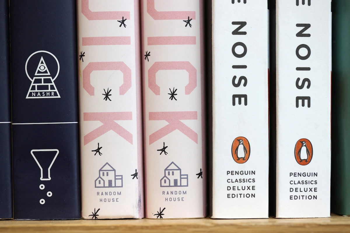 The Penguin and Random House logos are visible on the spines of books displayed on a shelf. (File/AFP)