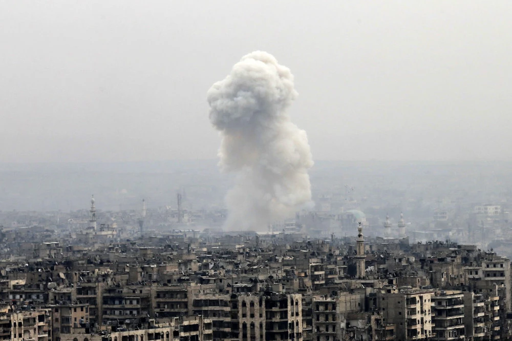 Smoke rises following a Syrian government air strike on rebel positions, in eastern Aleppo, Syria. (AP/File)
